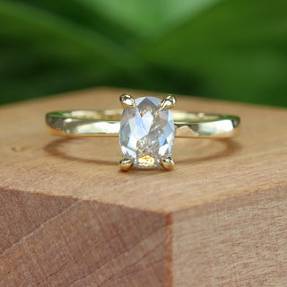Handmade 18ct gold oval salt and pepper diamond engagement ring on wooden surface.
