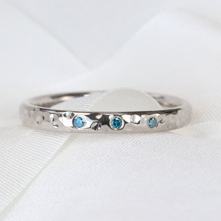 Handmade platinum hammered wedding ring with three blue diamonds, UK made.