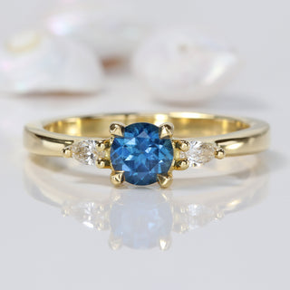 18ct gold blue sapphire trilogy engagement ring with pear cut diamonds