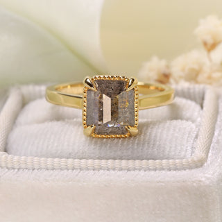 Handmade 18ct gold emerald cut salt and pepper diamond engagement ring on display stand.