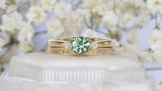 18ct gold Green sapphire and pear cut diamond trilogy engagement ring and slim orange blossom hand engraved wedding band