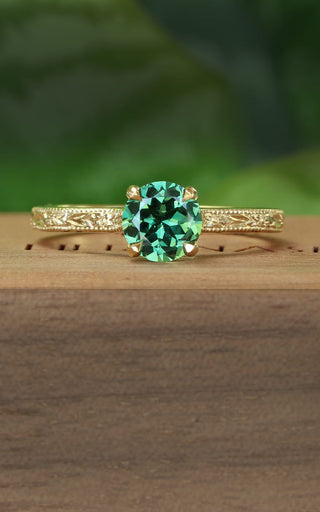 Green sapphire solitaire engagement ring with hand engraved orange blossom pattern