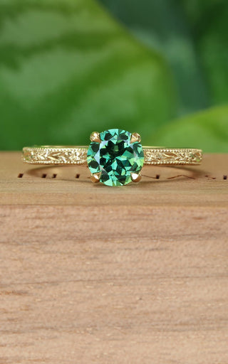 Green sapphire solitaire engagement ring with hand engraved orange blossom pattern