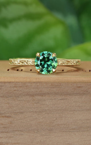 Green sapphire solitaire engagement ring with hand engraved orange blossom pattern