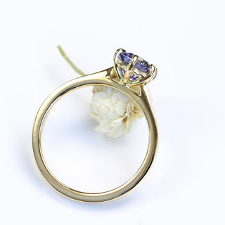 Handmade 18ct gold lavender sapphire engagement ring styled with light florals.