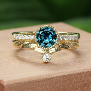 Leaf-engraved wishbone ring photographed in natural light on wooden surface