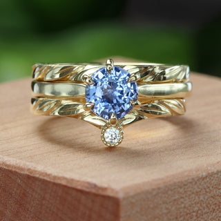 Gold wishbone ring stacked with sapphire engagement ring for styling inspiration