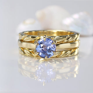 Slim carved leaf wedding band (bottom) with blue sapphire solitaire ring and carved leaves band