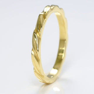 Slim 18ct gold wedding band with hand engraved leaves around the band