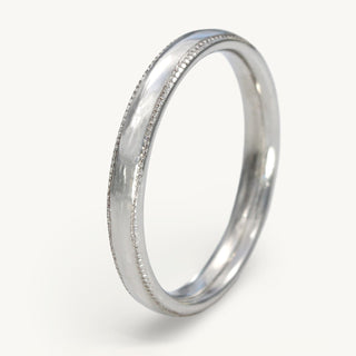 Handmade solid 950 platinum 2.5mm wide court profile wedding band with engraved milgrain detail along the edges of the band