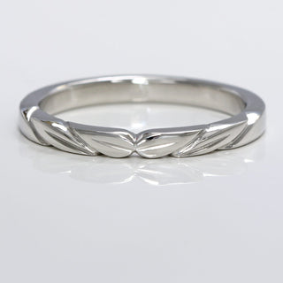 Platinum slim wedding band with hand engraved leaves at the front
