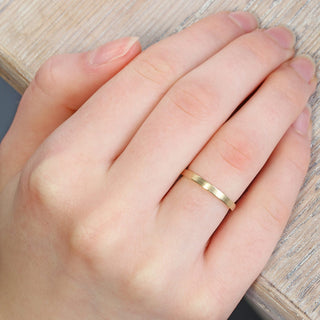 9ct gold 2mm slim flat profile wedding band worn on the hand