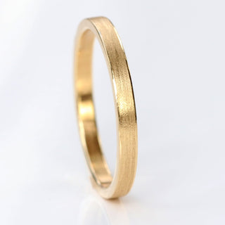 9ct gold slim 2mm wide wedding band in a flat profile with spun silk finish on a white background