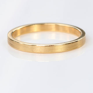 9ct gold slim 2mm wide wedding band in a flat profile with spun silk finish on white background