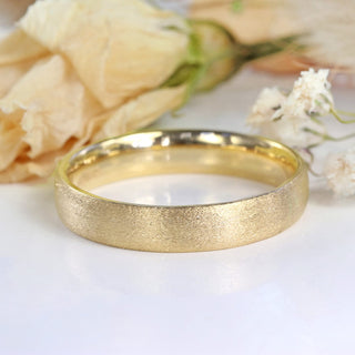 9ct gold 4mm court mens wedding band with spun silk finish on white background