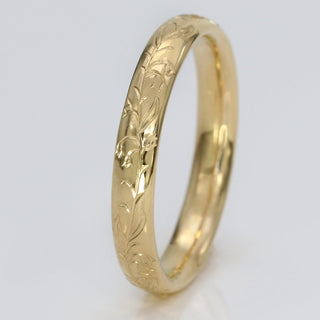 9ct gold 3mm court wedding band with hand engraved bluebells pattern shown on a white surface