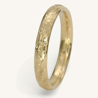 9ct gold 3mm court wedding band with hand engraved bluebells pattern shown on a white surface