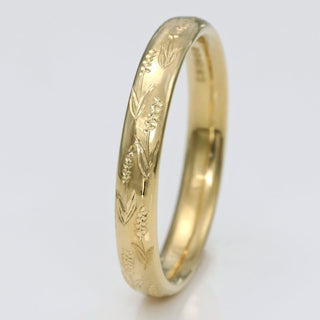 9ct gold 3mm court wedding band with hand engraved lavender flowers, on a white surface