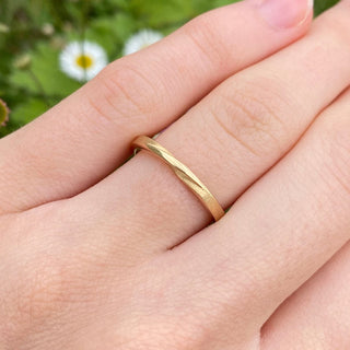 9ct gold ribbon twist wedding ring worn in the hand