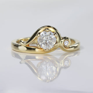 Handmade Art Nouveau 18ct gold engagement ring with icy diamond and small diamond accent on reflective surface.