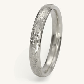 Platinum court wedding ring hand engraved with a bluebells pattern on a white surface