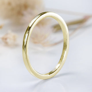 Skinny gold stacking ring on white background