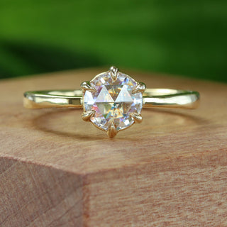 Custom made 18ct gold rose cut diamond solitaire engagement ring on a wooden box with blurred green background