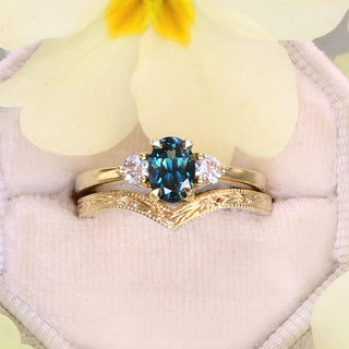 18ct gold deep teal sapphire and diamond trilogy ring with orange blossom engraved wishbone wedding ring