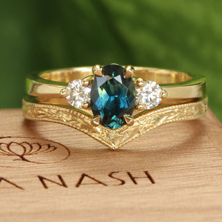 Teal sapphire and diamond 18ct gold trilogy engagement ring and orange blossom hand engraved wishbone wedding band