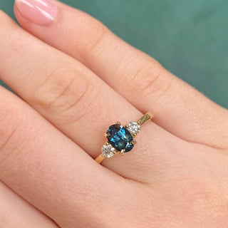 18ct gold Parti sapphire and diamond trilogy engagement ring shown worn on hand.
