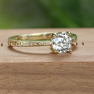 Side view of hand engraved old cut lab diamond solitaire engagement ring with vintage orange blossom pattern