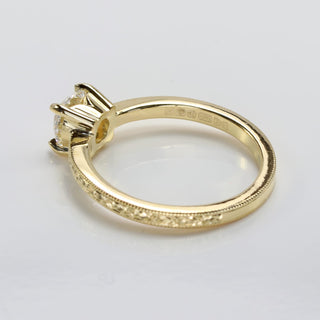 Top view of vintage inspired lab diamond 18ct gold solitaire engagement ring with hand engraved vintage orange blossom pattern.