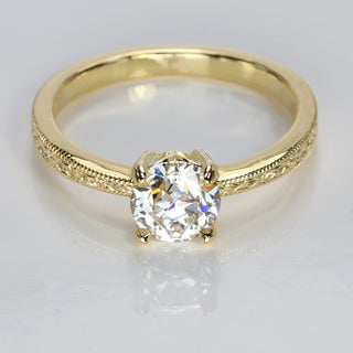 Top view of old European cut lab diamond 18ct gold solitaire engagement ring with hand engraved orange blossom patterned band