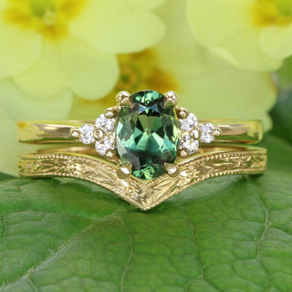 Ennys oval green sapphire and diamond cluster ring with hand engraved orange blossom wishbone wedding band