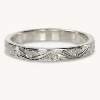 Hand engraved 3mm wide platinum wedding ring. The floral engraving continues around the band