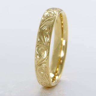 18ct gold wedding band in a 4mm court profile with hand engraved floral scroll pattern