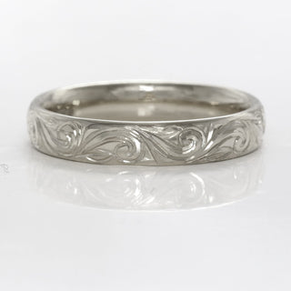 Hand engraved platinum wedding ring in a 4mm court profile with hand engraved floral scroll detail