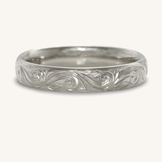 Hand engraved platinum wedding ring in a 4mm court profile with hand engraved floral scroll detail