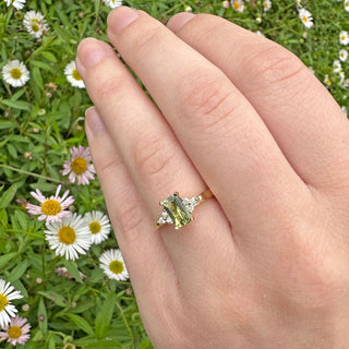 Parti sapphire and diamond engagement ring, handmade from sustainable 18ct gold in Cornwall. Worn on the and with daisies in background