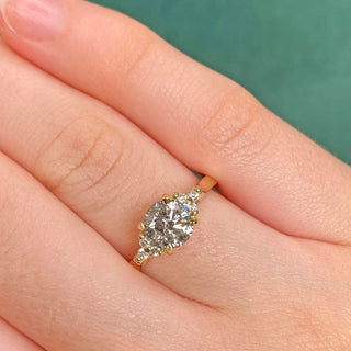 Salt and pepper diamond cluster engagement ring in 18ct gold shown worn on hand.