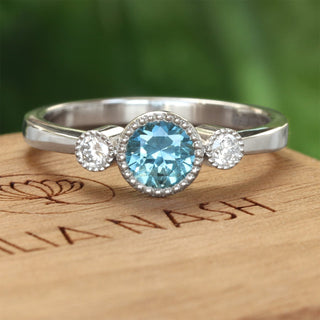 Platinum trilogy engagement ring with fair trade blue sapphire and dimaonds
