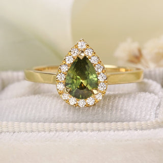 Handmade 18ct gold halo engagement ring with green sapphire and diamonds on felt ring box.