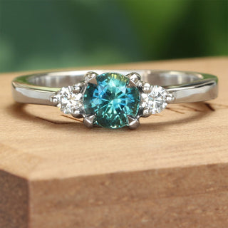 Platinum Teal blue sapphire and diamond trilogy ring
