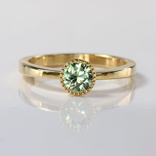 Green sapphire 18ct gold solitaire engagement ring with milgrain detail