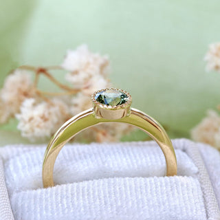 Side view of 18ct gold green sapphire solitaire engagement ring showing raised bezel setting.