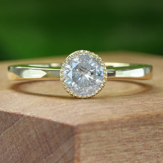 18ct gold icy diamond solitaire ring on wooden block