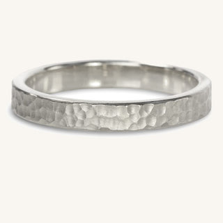 Handmade 3mm wide platinum wedding band with a dappled hammered texture