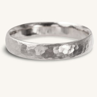 Handmade 4mm court platinum wedding band with a dappled hammered finish