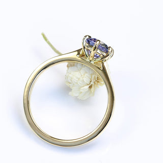 Handmade 18ct gold lavender sapphire engagement ring styled with light florals.