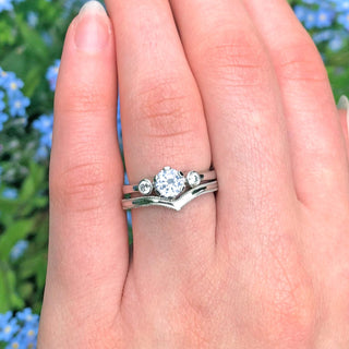 Platinum diamond trilogy ring and wishbone wedding ring with hand engraved milgrain border